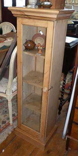 Tall narrow stripped pine display cabinet with three shelves...