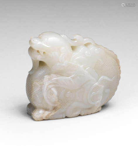 A RARE PALE GREEN JADE CARVING OF A MYTHICAL BEAST Ming Dyna...