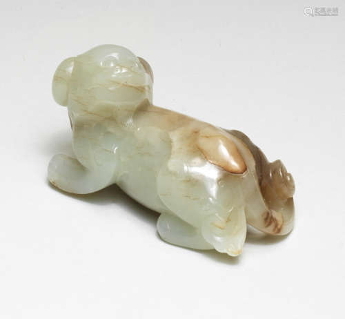 A PALE GREEN AND RUSSET JADE CARVING OF A DOG Ming Dynasty