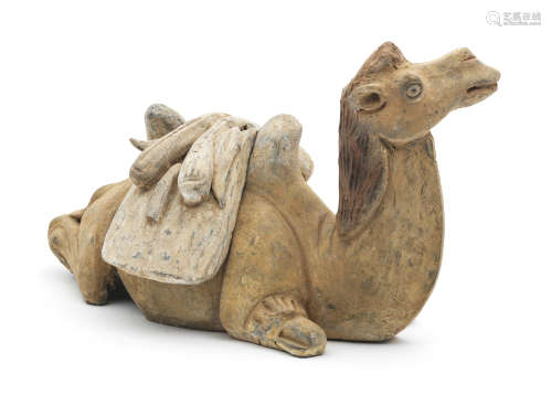 A FINE PAINTED POTTERY MODEL OF A CAMEL Tang Dynasty