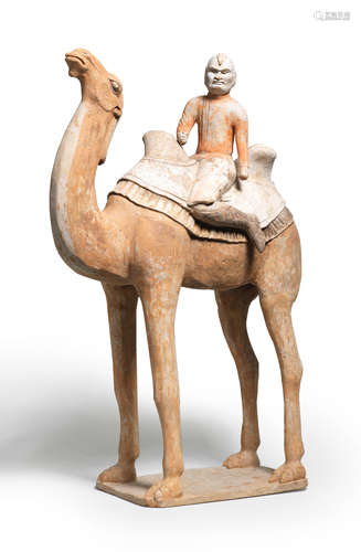 A LARGE PAINTED POTTERY MODEL OF A CAMEL WITH A 'FOREIGNER' ...