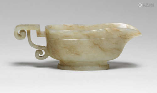 AN ARCHAISTIC PALE GREEN AND RUSSET JADE POURING VESSEL, YI ...