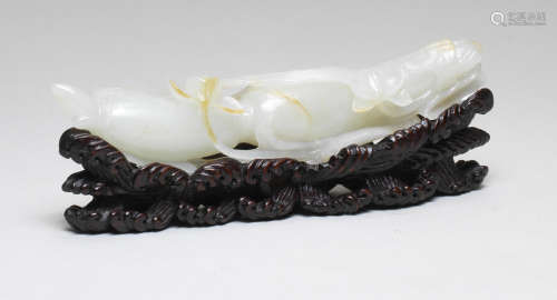 A FINE WHITE AND RUSSET JADE CARVING OF A LOTUS ROOT 18th ce...