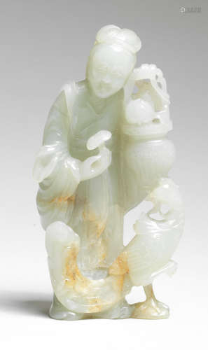 A PALE GREEN AND RUSSET JADE FIGURE OF MAGU 18th century