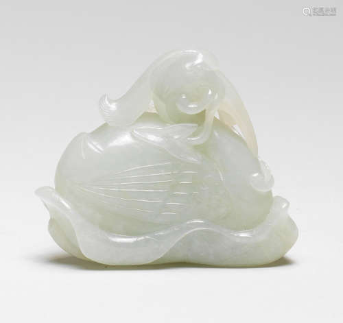 A PALE GREEN JADE CARVING OF AN EGRET AND LOTUS 18th century