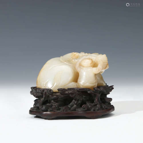 A Carved White Jade Boy And Ox Ornament With Stand