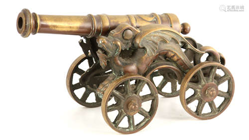 A 19TH CENTURY BRONZE STARTING CANNON mounted on a carriage ...