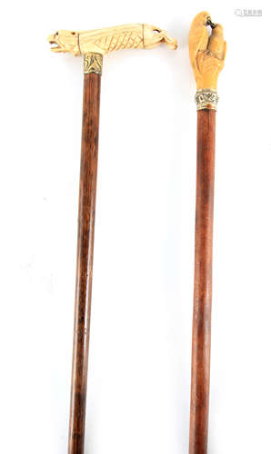 A 19TH CENTURY CARVED WALKING STICK with carved dog handle m...