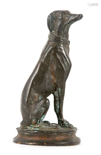 A CAST BRONZE SEATED FIGURE OF A DOG after Barye; on circula...