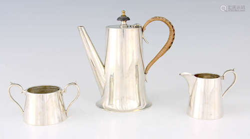 A 1920'S SILVER THREE PIECE TEA SET of tapered form, the tea...