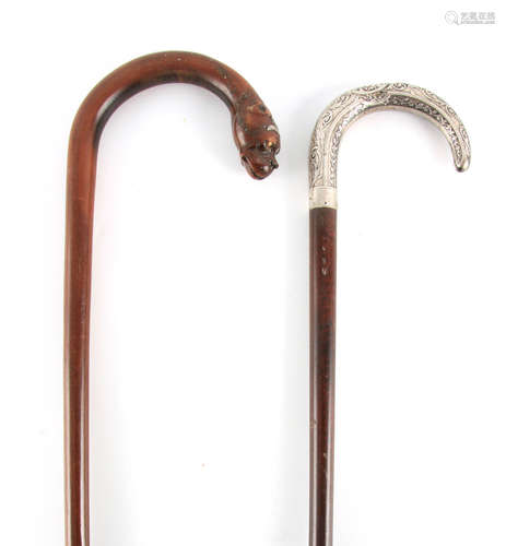 TWO 19TH CENTURY MAHOGANY WALKING STICKS one with hooped car...