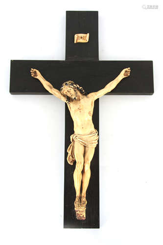 A 19TH CENTURY CORPUS CHRISTI mounted on an ebony cross 38cm...