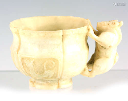 A CHINESE ARCHAISTIC JADE CUP of leaf-shaped form with panel...