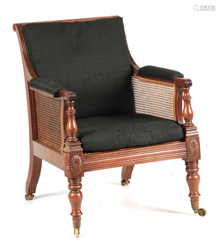 A REGENCY MAHOGANY BERGERE LIBRARY CHAIR OF GENEROUS PROPORT...