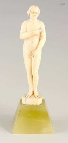 AN ART DECO SMALL IVORY STANDING NUDE FIGURE OF A LADY WITH ...