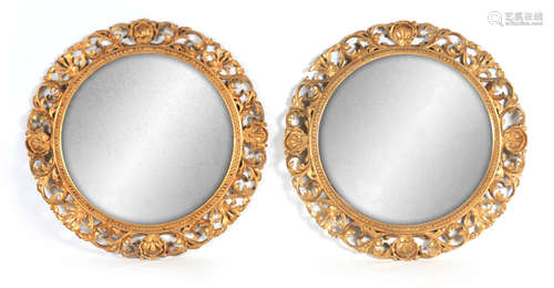 A PAIR OF LATE 19TH CENTURY FLORENTINE CIRCULAR GILT MIRRORS...