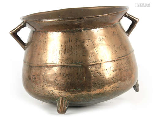 A 17TH CENTURY CAST BRONZE WEST COUNTRY TWO HANDLED CAULDRON...