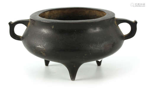 AN ORIENTAL BRONZE CENSER of squat form with triangular hand...