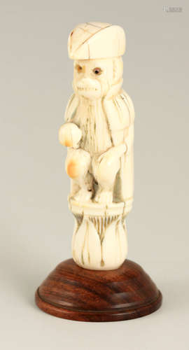 AN EARLY CARVED IVORY FIGURE depicting a Monkey dressed as a...