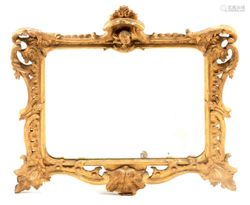 AN 18TH CENTURY CARVED GILTWOOD HANGING MIRROR with leaf wor...