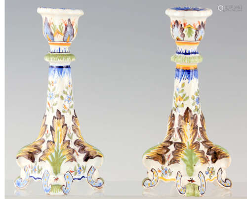 A PAIR OF FRENCH FAIENCE POTTERY CANDLESTICKS decorated with...