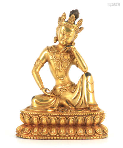 A GILT BRONZE TIBETAN BUDDHA depicting a seated Deity, on a ...
