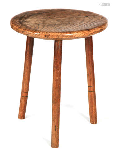 A 19TH CENTURY SMALL ELM CRICKET TABLE the thick highly figu...