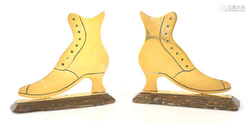 A PAIR OF 19TH CENTURY BRASS BOOTS on detachable stands 13 c...