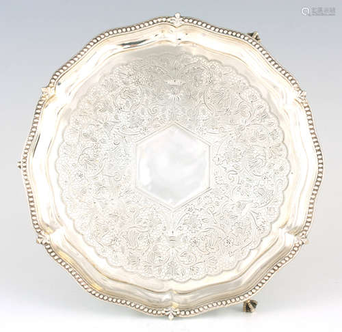 A VICTORIAN PROFUSELY ENGRAVED SCALLOP-EDGE SILVER SALVER wi...