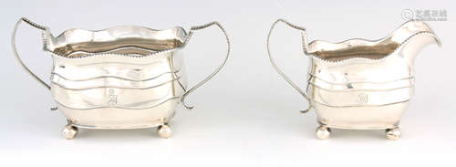 A LARGE GEORGE III TWO-PIECE IRISH SILVER CREAM AND SUGAR BA...