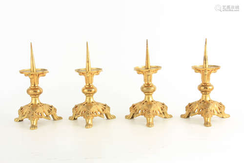 A SET OF FOUR 19TH CENTURY GILT BRONZE PRICKET STICKS cast w...