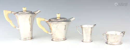 A GEORGE VI FOUR PIECE SILVER TEA AND COFFEE SERVICE OF ART ...