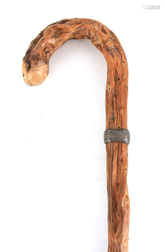 A CONTINENTAL KNARLED ROOT WOOD WALKING STICK with basketwea...