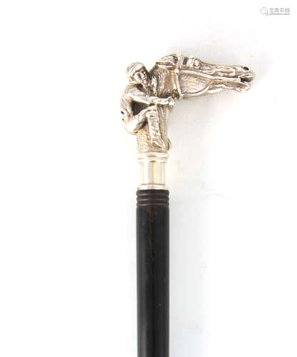 AN EARLY 20TH CENTURY SILVER TOPPED WALKING STICK OF EQUESTR...