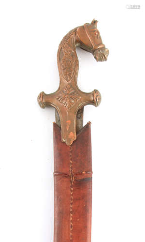 A 19TH CENTURY INDIAN TULWAR SWORD having a copper handle fo...