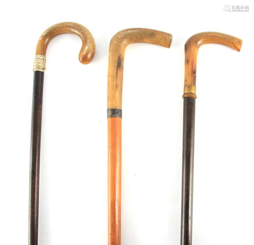 THREE 19TH CENTURY RHINO HORN HANDLED WALKING STICKS one wit...