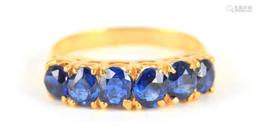 A LADIES SIX STONE BURMESE SAPPHIRE RING having cushion sett...