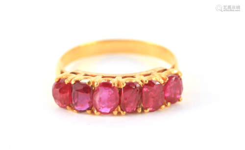 A LADIES SIX STONE BURMESE RUBY RING cushion set in a yellow...