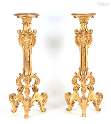 A PAIR OF GILT GESSO TORCHERES of rococo design with scrolle...