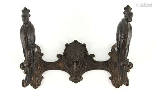 A BRONZE METAL COAT RACK BY PAUL KOCH with central mask hook...