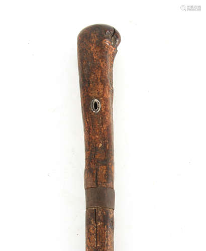 AN EARLY 18TH CENTURY SWORD STICK with full bark shaft and i...