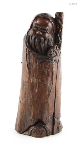A LARGE CHINESE CARVED TRUNK DEPICTING A FIGURE OF AN IMMORT...