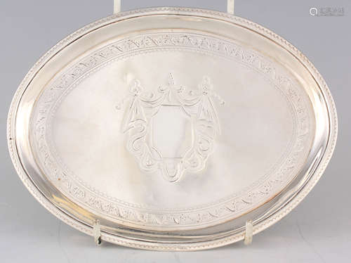 A GEORGE III OVAL BRIGHT CUT ENGRAVED SILVER TEAPOT STAND wi...