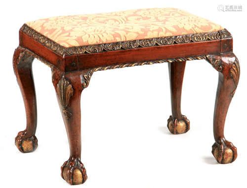 A GEORGE I STYLE WALNUT AND GILT DECORATED STOOL with leaf m...