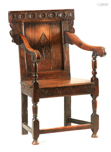 A LATE 17TH CENTURY JOINED OAK OPEN ARMCHAIR with scroll and...