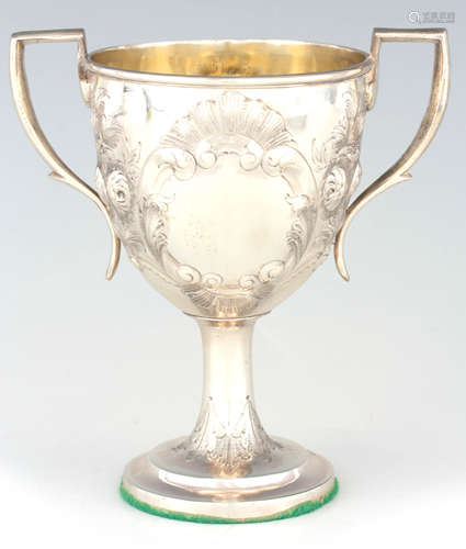 A GEORGE III IRISH SILVER TWO HANDLED EMBOSSED LOVING CUP wi...