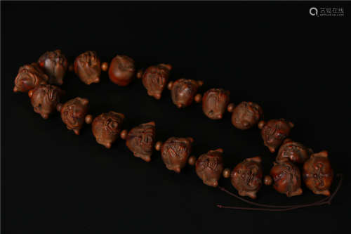 A STRING OF HANDHELD 18 DRILLED BAMBOO SEED BEADS