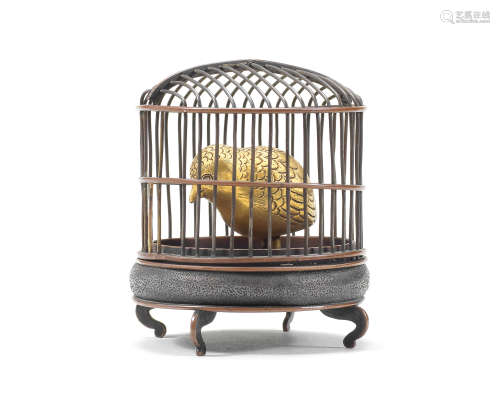 A miniature bronze and gilt okimono of a bird and cage Meiji...
