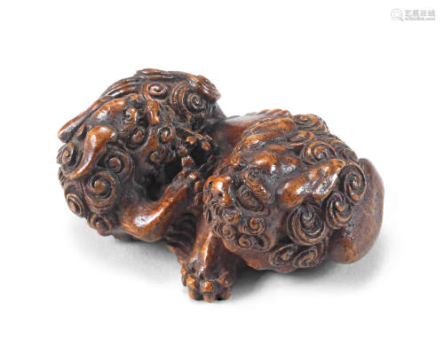 A bamboo netsuke group of two shishi (Chinese mythological l...