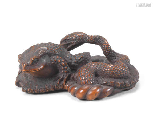 A large boxwood netsuke of a toad and snake By Masanao, Ise,...